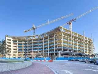 Erected precast/steel hybrid parkade field photo with cranes